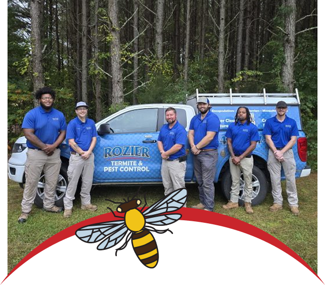 A Rozier Termite and Pest Control technician beside a branded service truck